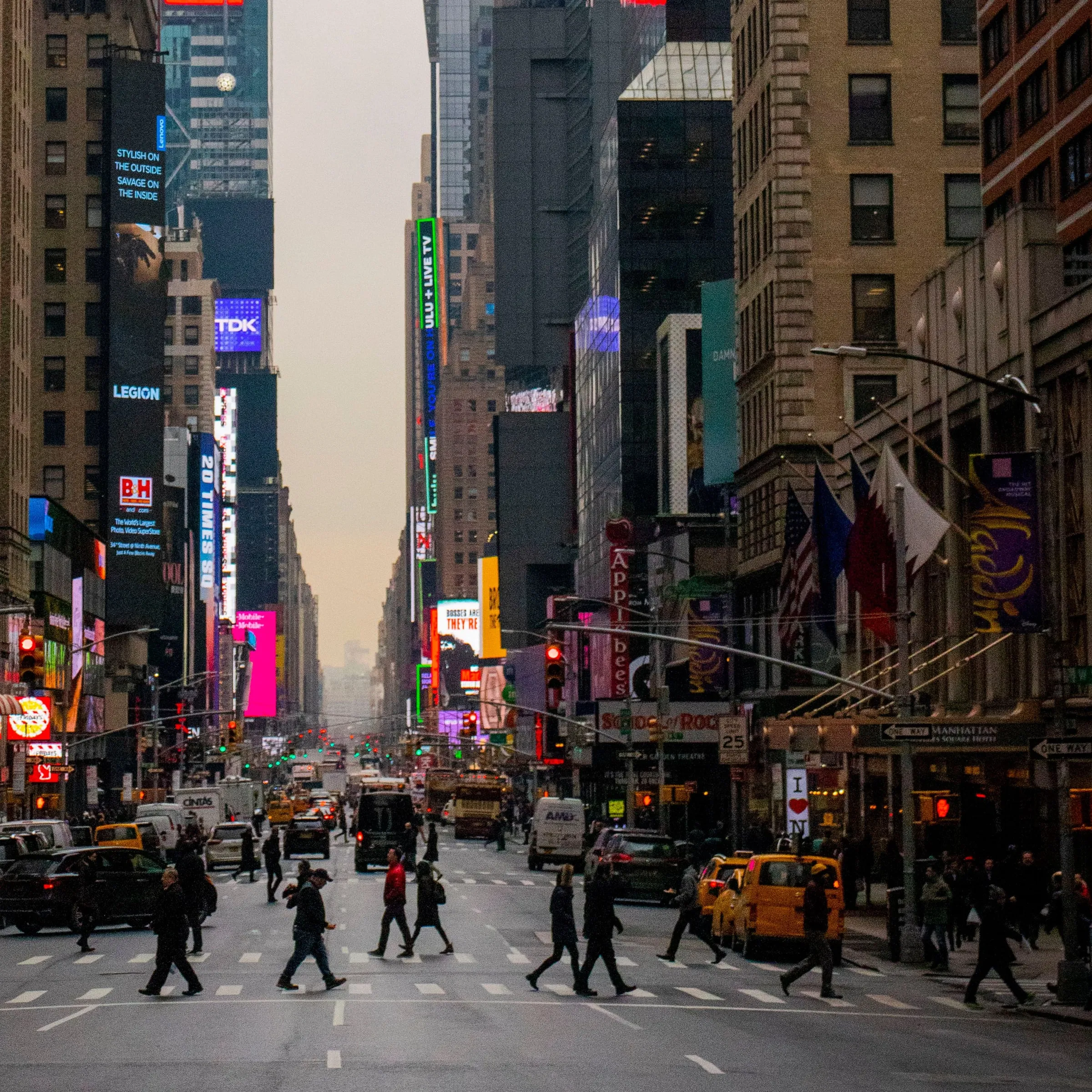 Pedestrians and traffic on a New York street at dusk, with detection boxes drawn around them