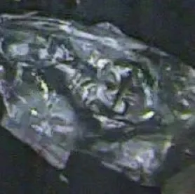 Cropped photo of a crushed blue bottle