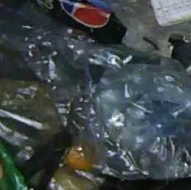 Cropped photo of a crushed blue bottle