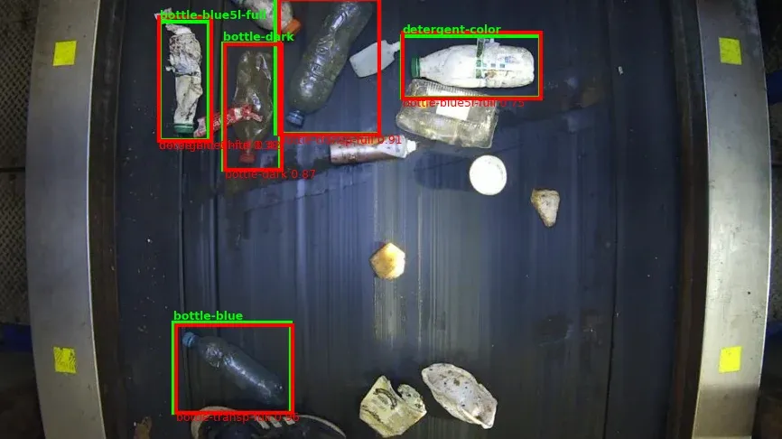 Bottles on a conveyor belt with ground-truth and predicted boxes